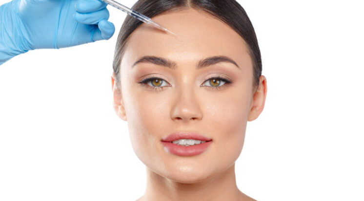 Portrait of an attractive young woman receiving botox treatment.